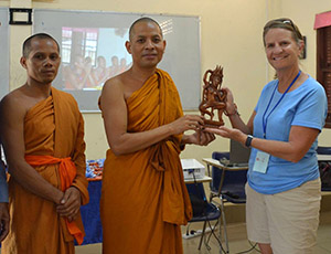 Stacy receiving gift from Venerable Sovechea
